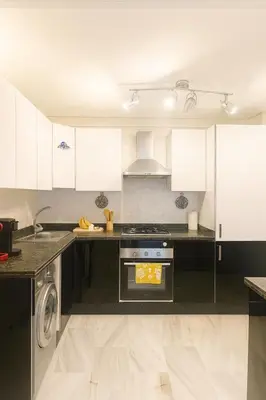 a kitchen with white cabinets and a stove at Chic 1 bedroom WiFi apartment Marrakech in Marrakech