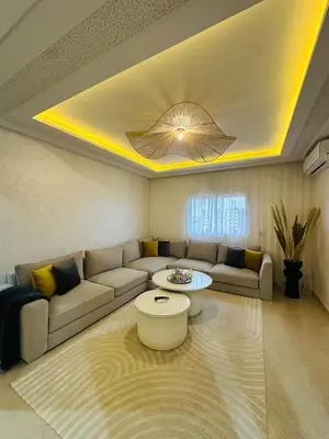 a living room with a couch and a table at Elegant 2 Bedrooms with Pool & Wi-Fi Marrakech in Marrakech