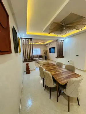 a dining room with a wooden table and chairs at Elegant 2 Bedrooms with Pool & Wi-Fi Marrakech in Marrakech