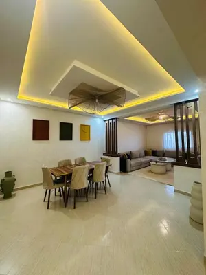 a living room with a table and chairs and a couch at Elegant 2 Bedrooms with Pool & Wi-Fi Marrakech in Marrakech