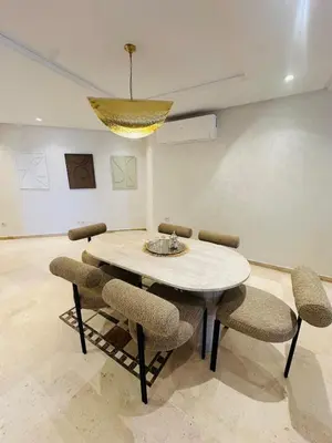 a dining room table with chairs and a chandelier at Sublime 2 bedrooms with pool and Wi-Fi Marrakech in Marrakech