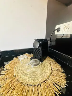 two glasses on top of a wicker table next to a toaster at Sublime 2 bedrooms with pool and Wi-Fi Marrakech in Marrakech