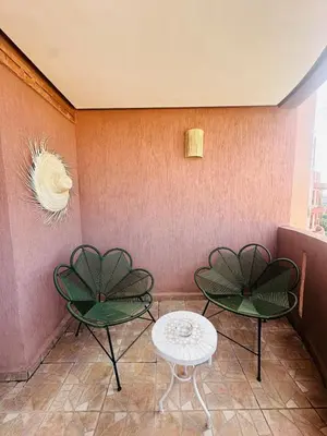two chairs and a table in a room at Sublime 2 bedrooms with pool and Wi-Fi Marrakech in Marrakech