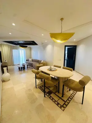 a living room with a dining room table and chairs at Sublime 2 bedrooms with pool and Wi-Fi Marrakech in Marrakech