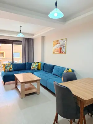 a living room with a blue couch and a table at A21 Moderne Confort Au Cœur De Marrakech in Marrakech