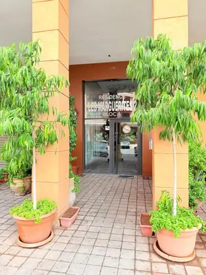 an entrance to a building with trees in front of it at A21 Moderne Confort Au Cœur De Marrakech in Marrakech
