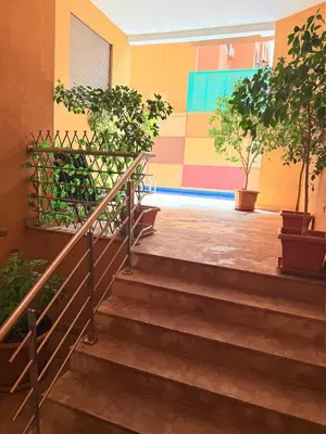 a set of stairs with potted trees in a building at A21 Moderne Confort Au Cœur De Marrakech in Marrakech