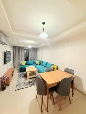 a living room with a blue couch and a table at A21 Moderne Confort Au Cœur De Marrakech in Marrakech