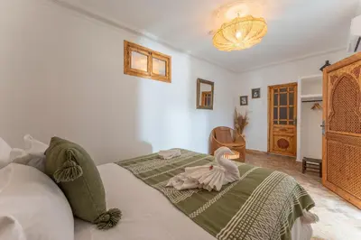 a bedroom with a bed with a towel on it at Riad OM SAADENE in Marrakech