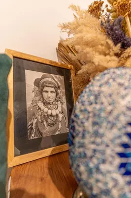 a picture of a woman on a table next to a plate at Riad OM SAADENE in Marrakech