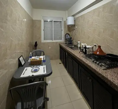 a kitchen with a counter and a sink and a stove at Modern Apartment Near Airport in Marrakech