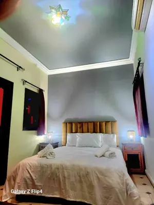 a bedroom with a bed with two towels on it at Riad Ibrahim in Marrakech