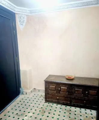 a room with a wooden dresser in the corner of a room at Riad Ibrahim in Marrakech