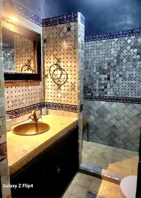 a bathroom with a sink and a shower at Riad Ibrahim in Marrakech