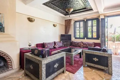 a living room with a couch and a fireplace at Beautiful villa with a private pool in La Palmeraie neighborhood in Marrakech
