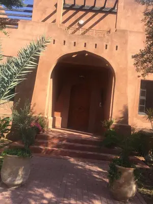 an entrance to a building with a brown door at Beautiful villa with a private pool in La Palmeraie neighborhood in Marrakech