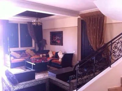 a living room with a couch and a table at Beautiful villa with a private pool in La Palmeraie neighborhood in Marrakech