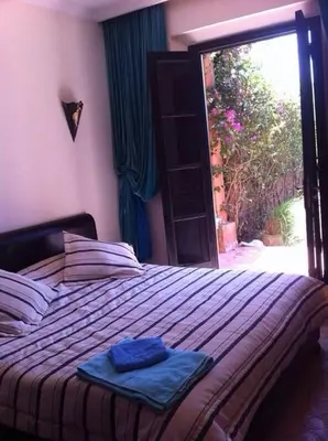 a bedroom with a bed with two towels on it at Beautiful villa with a private pool in La Palmeraie neighborhood in Marrakech