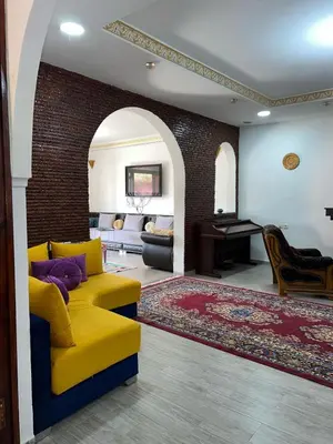 a living room with a yellow couch and a piano at Riad suite for families and groups in Marrakech