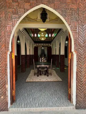 an archway with a table in the middle of a building at Riad suite for families and groups in Marrakech