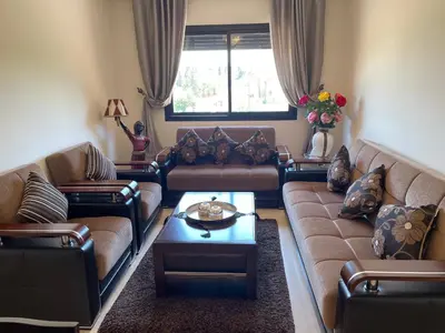 a living room with couches and a coffee table at Apartement de Luxe mit Tiefgarage in Marrakech