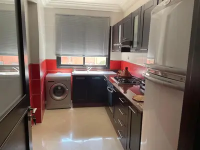 a small kitchen with a washer and dryer at Apartement de Luxe mit Tiefgarage in Marrakech