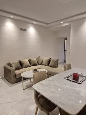 a living room with a couch and a table at Elegant & Comfortable Apartment in Marrakesh in Marrakech