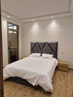 a bedroom with a large bed with white sheets at Elegant & Comfortable Apartment in Marrakesh in Marrakech