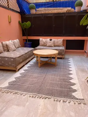 a living room with a couch and a coffee table at Appartement luxueux Gueliz in Marrakech