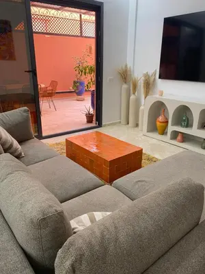 a living room with a couch and a coffee table at Appartement luxueux Gueliz in Marrakech