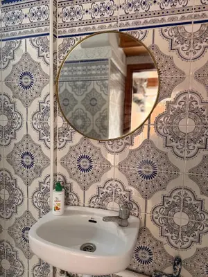 a bathroom with a sink and a mirror at Julie Airport Boarding Apartment in Marrakech