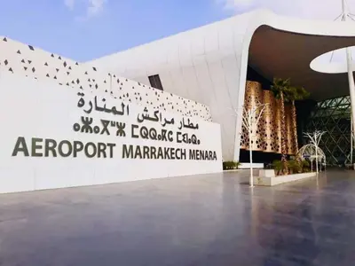 a sign for the entrance to the argent import market market malreact mahan at Julie Airport Boarding Apartment in Marrakech