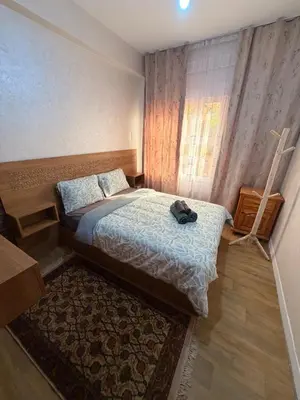 a small bedroom with a bed and a window at Julie Airport Boarding Apartment in Marrakech