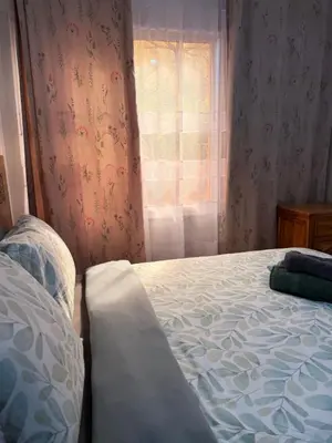 a bedroom with a bed and a window at Julie Airport Boarding Apartment in Marrakech