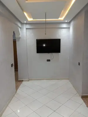 a room with a television on a white wall at Cozy with Moroccan flair in Marrakech