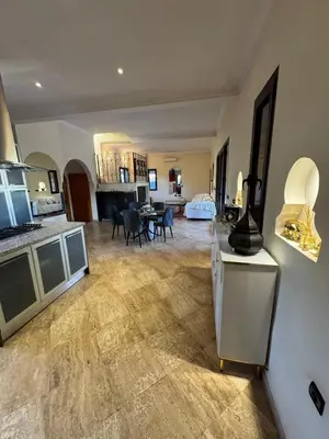 a large room with a kitchen and a living room at Splendide Villa avec piscine in Marrakech
