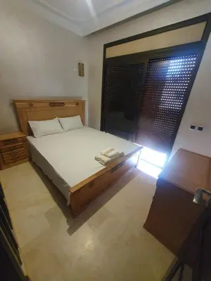 a bedroom with a large bed and a window at Palace-Apartment-Marrakech in Marrakech