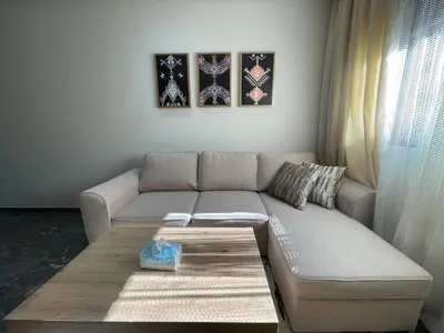 a living room with a couch and a coffee table at High-End Cozy and Modern Studio in Marrakech