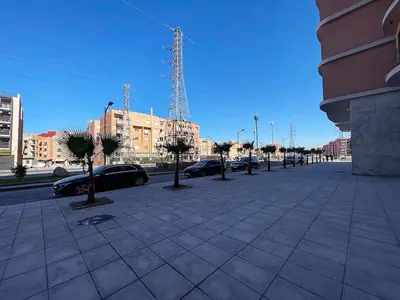 a street with cars parked in a city at High-End Cozy and Modern Studio in Marrakech