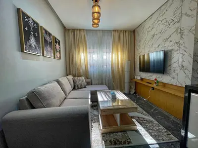 a living room with a couch and a coffee table at High-End Cozy and Modern Studio in Marrakech