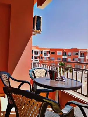 a table and chairs on the balcony of a apartment at Appartement calme et spacieux pour famille in Marrakech