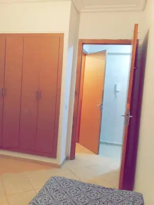 a room with two sliding doors and a mirror at Appartement calme et spacieux pour famille in Marrakech