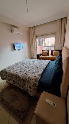 a bedroom with a large bed and a window at MELBARI Central-Appart in Marrakech