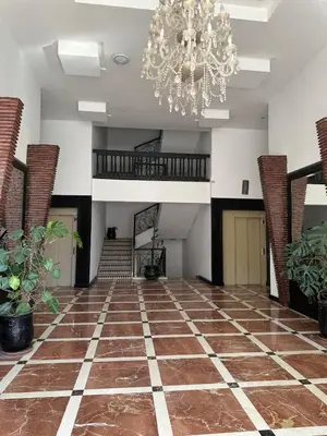 a large room with a chandelier and a floor at MELBARI Central-Appart in Marrakech