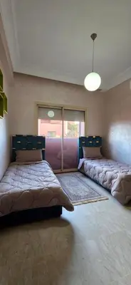 a large room with two beds in it at MELBARI Central-Appart in Marrakech