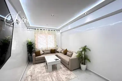 a living room with a couch and a table at Stylish & Cozy Apartment in Marrakech in Marrakech