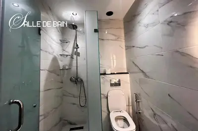 a bathroom with a toilet and a shower stall at Stylish & Cozy Apartment in Marrakech in Marrakech