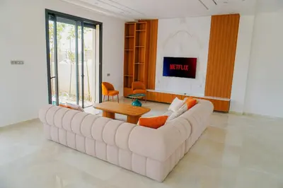 a living room with a large couch and a table at Villa Emeraude 15 minutes du centre in Marrakech