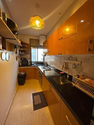 a kitchen with wooden cabinets and a sink at Sultana in Marrakech