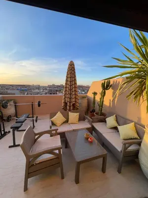 a living room with a couch and chairs on a roof at Sultana in Marrakech